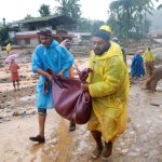 Rescuers carry a body following a landslide in Wayanad, in the southern state of Kerala, India