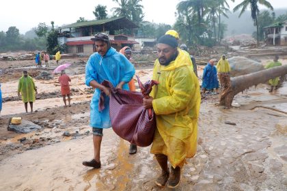 Rescuers carry a body following a landslide in Wayanad, in the southern state of Kerala, India