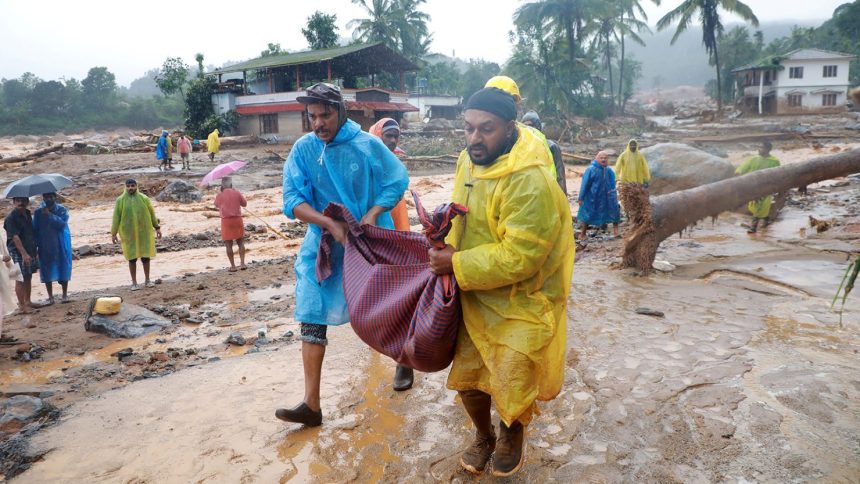 Rescuers carry a body following a landslide in Wayanad, in the southern state of Kerala, India