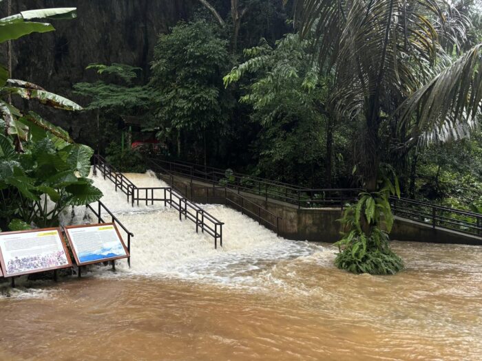 the water rushing out of the cave’s entrance is stronger than a waterfall