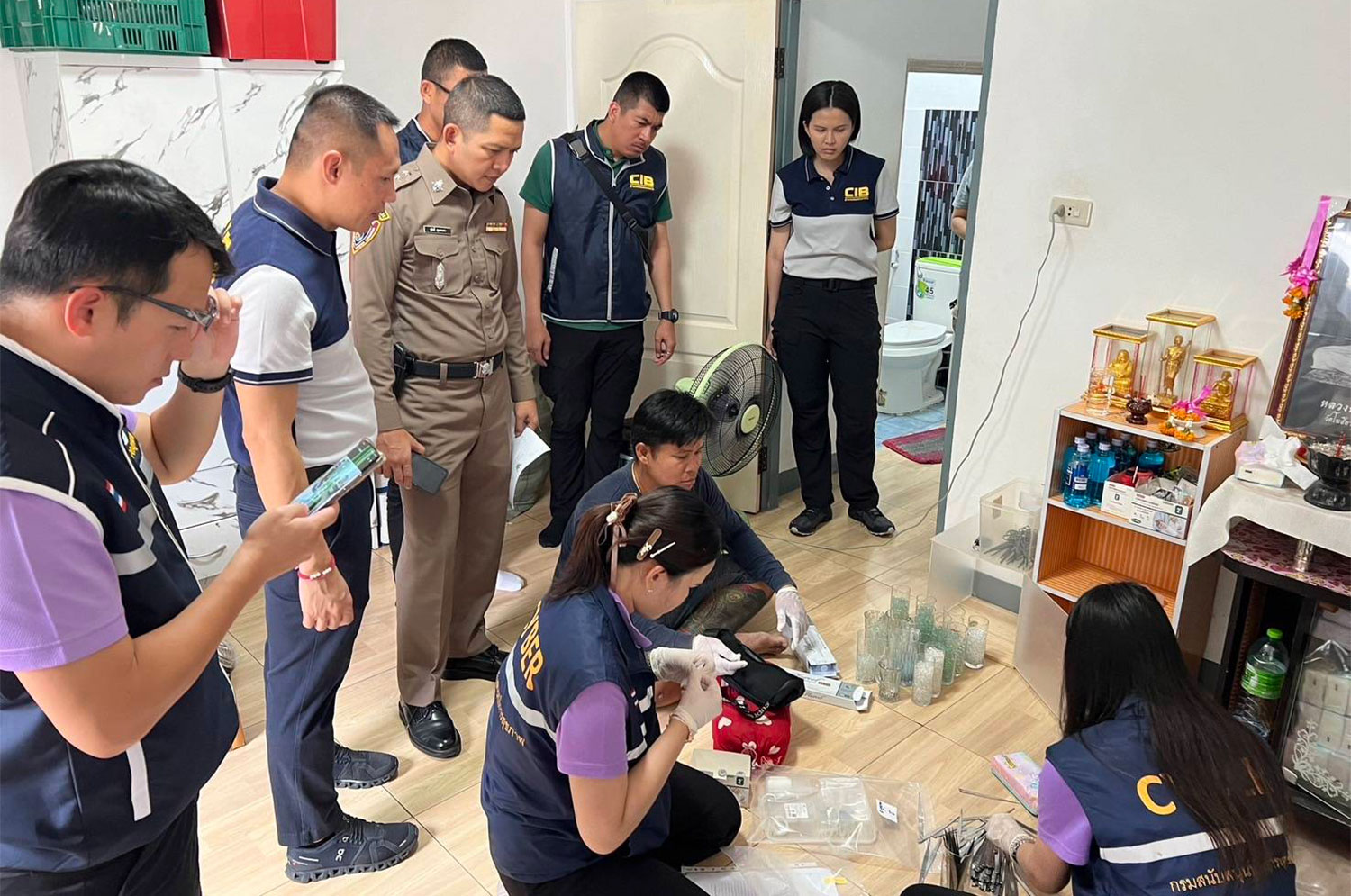 Consumer protection police and health officials examine materials used in illegal penis enlargement treatments