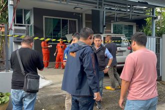 Police examine the crime scene after retired army officer kills his neighbour - Police Image