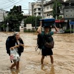 Tourists Wade through flood waters in Chiang Mai City