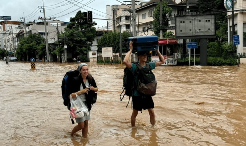 Tourists Wade through flood waters in Chiang Mai City