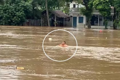 Chinese man swims in the Ping River, Chiang Mai