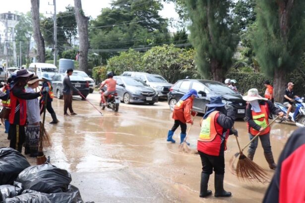 District workers in Chiang Mai clean mud from the streets