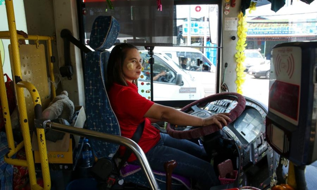 Yin Yin Aye, a Yangon Bus Service (YBS) public transportation bus driver, drives a bus on the road in Yangon, Myanmar