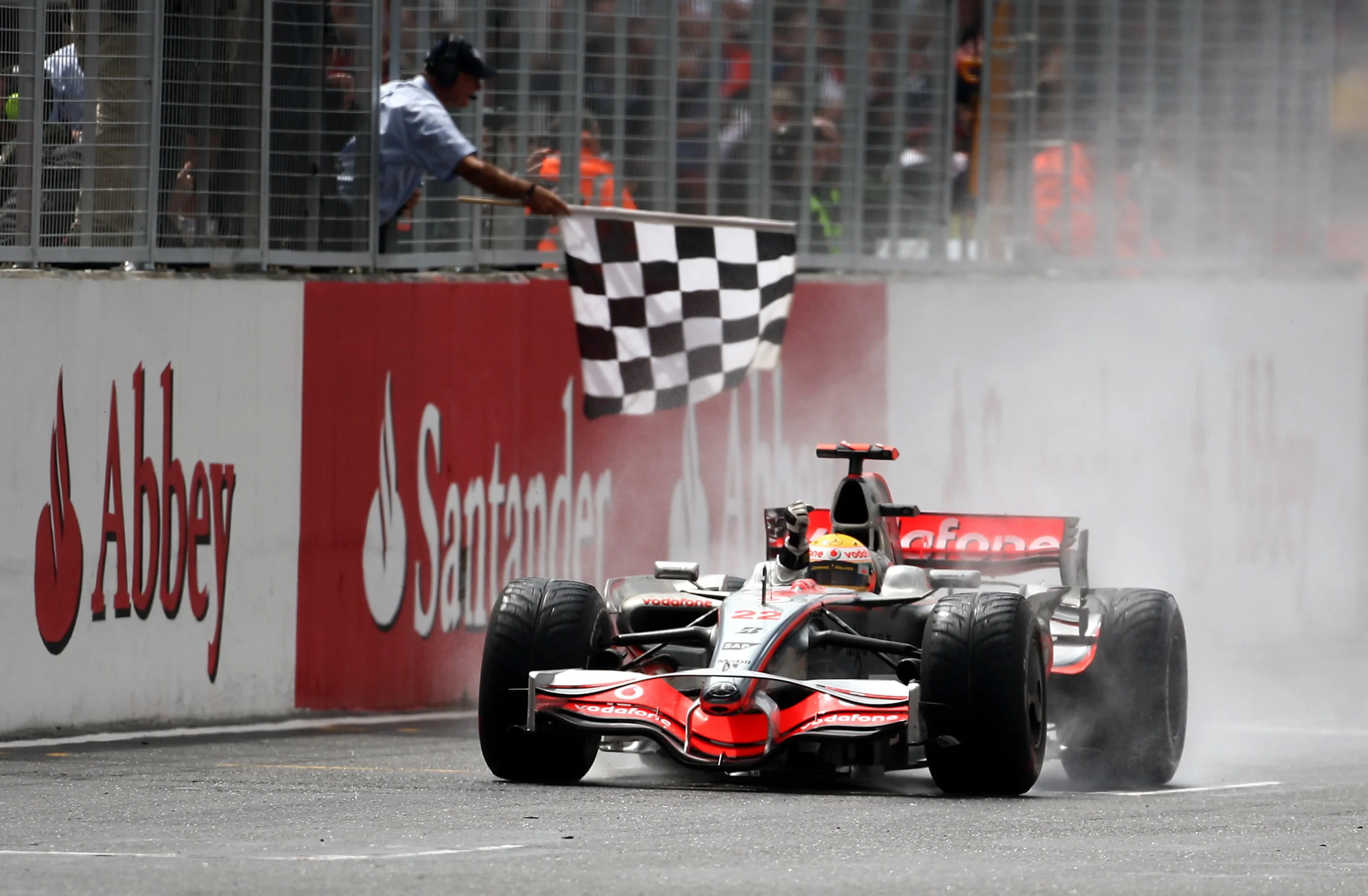 Lewis Hamilton takes the chequered flag at the 2008 British Grand Prix